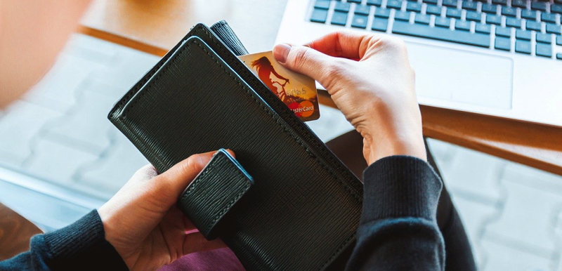 women at laptop with wallet and credit card