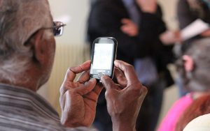 elderly man holding mobile phone