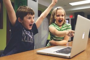 children on computer looking excited