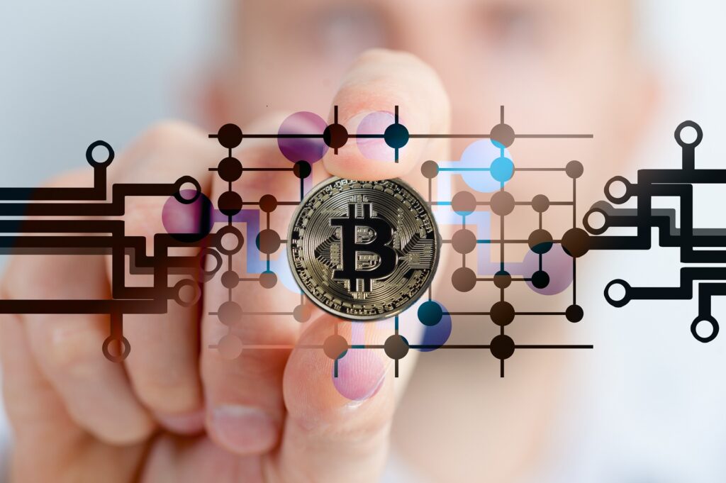 Image of a person blurred in the background, holding a bitcoin with some graphics in the front of the image