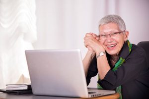 elderly lady at laptop smiling