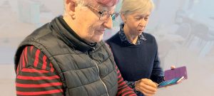 two women holding mobile phones, tech-savvy seniors