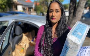 Volunteer holding essential items to help during lockdown