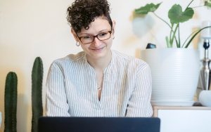 lady at computer, smiling