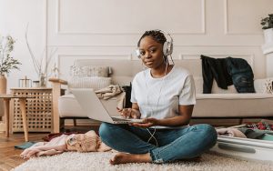 lady sitting on her laptop listening to music