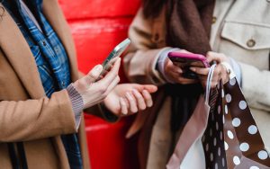 focus on two people's hands as they hold mobile phones