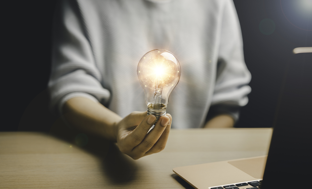 woman holding a light bulb